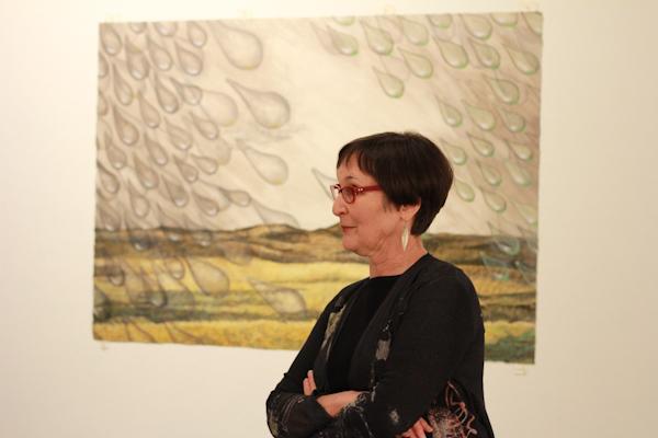 Photo by Amy Price | Artist Judy Youngblood discusses one of her pieces during the reception.