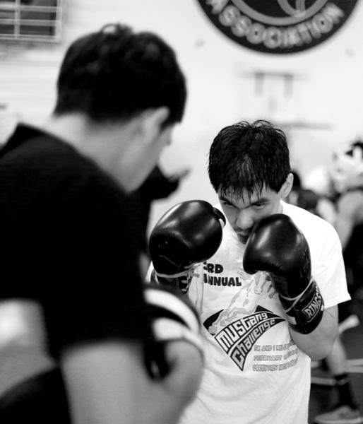 George Rincon practices punching a moving target with his brother, Alex.