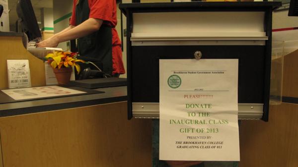 Photo by Nicholas Bostick | The donation box for the SGA student gift sits in front of the cashiers inside the Brookhaven bookstore.