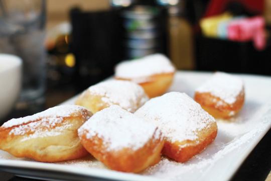 Photos by Kathy Tran and Scott Mitchell | The beignets, fluffy air-filled pastries covered in powdered sugar, offer a sweet dessert to go along with a latte.