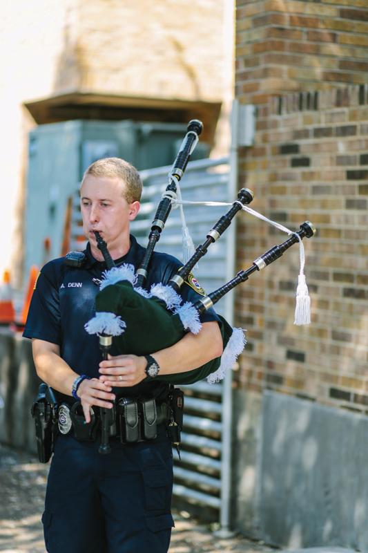 Photo by Kathy Tran | Brookhaven College Police Department Officer Aaron Denn plays for a crowd on campus at the Piper Awards.