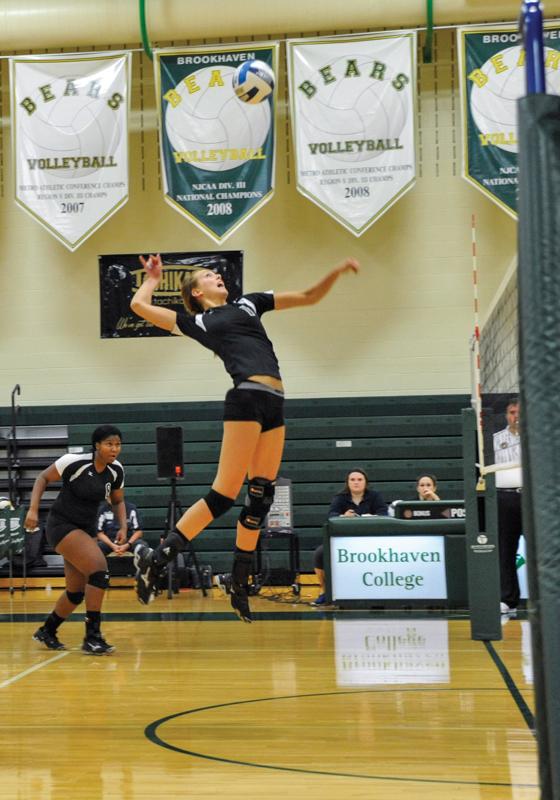 Photos by Scott Godbey and Maddox Price | leading the game in kills, middle blocker Cadyn Laing leaps for a successful shank