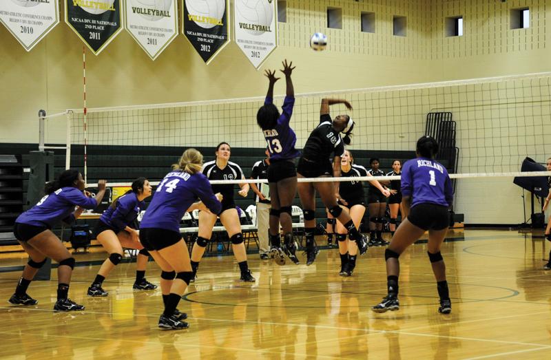 Kim Parker, middle blocker, jumps for an aggressive attack