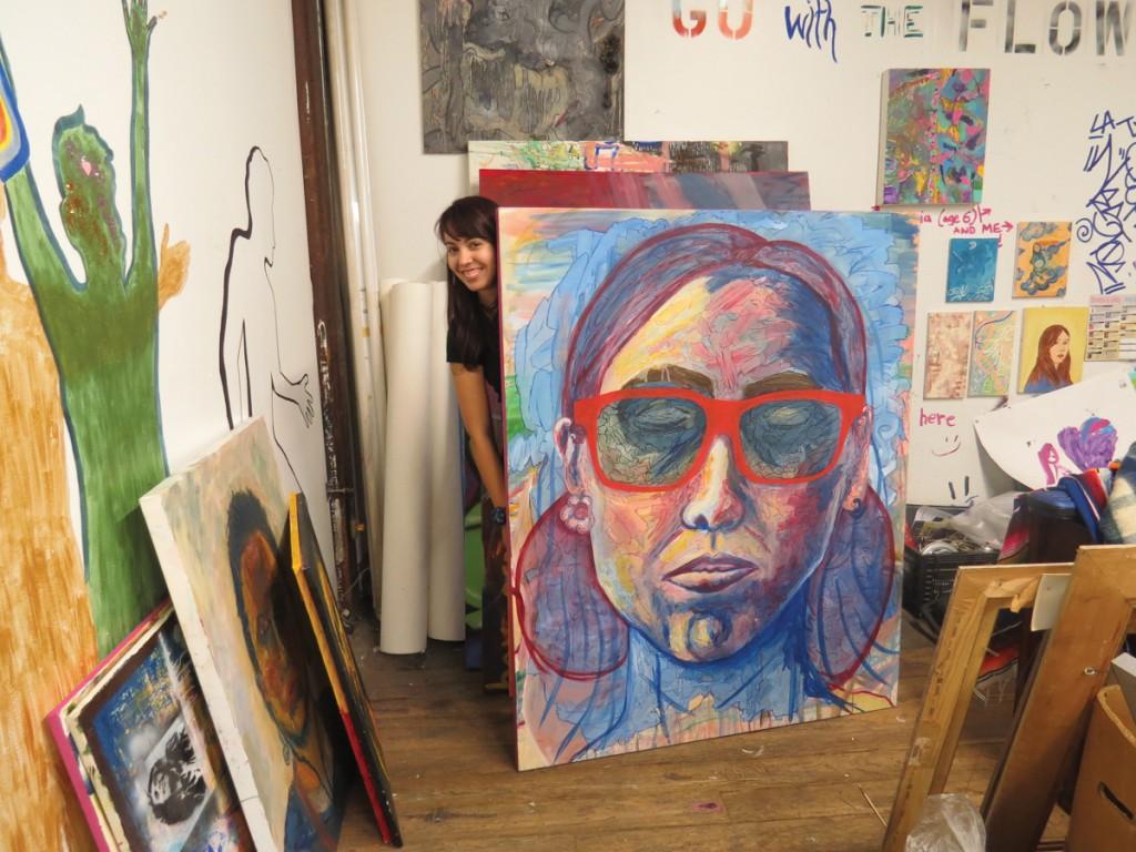 Photo by Carmina Tiscareño | Karla Aseneth Ceballos peeks from behind one of her works in Studio 3C3. 