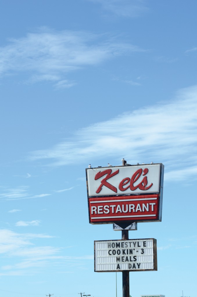 Photo by Travis Baugh  | The sign for Kel's Restaurant, worn and decorated with pigeons.