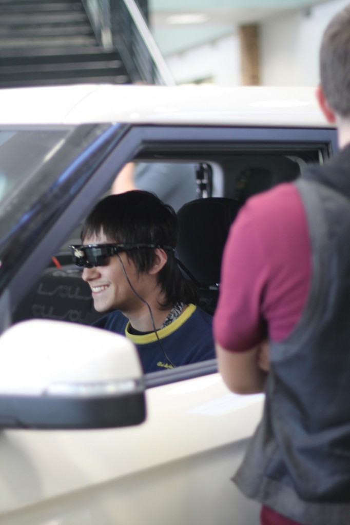 Jose Perez dons virtual drunk driving glasses in a simulation car during the National Collegiate Alcohol Awareness event.
