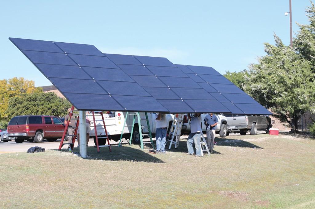 Photo by Brigitte Zumaya | Workers install solar panels on Brookhaven campus.  