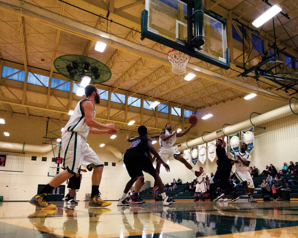 Photos by Scott Godbey and Brian Finch | Kenny Slocum (#10) pulls up for a jump shot in the defender’s face after manuvering through the defense