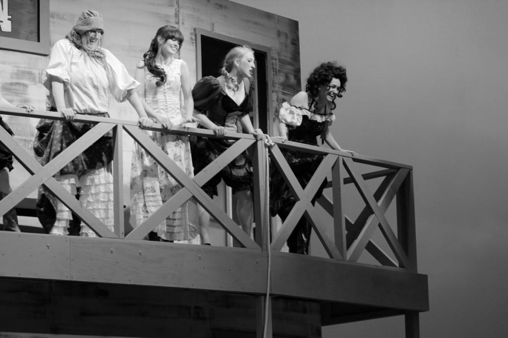 Photos by Ravin Lee | Debbie Stromquist, Chloe Hedrick, Rebecca White and Mar Llavador stand seductively on the second story of the saloon. 