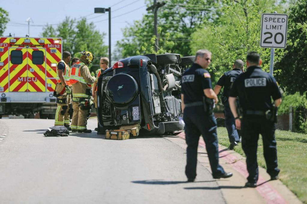 Photo by Kathy Tran | A flipped SUV rests at the Valley View Lane exit to Brookhaven College. The April 28 accident involved the use of a cell phone, according to the police report. The city of Farmers Branch passed an ordinance March 18 making text-based communications illegal while driving. 