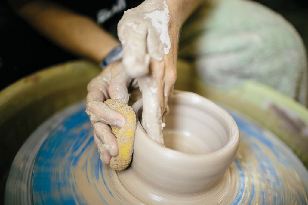 Photos by Kathy Tran |A student smooths the sides of a new bowl. 