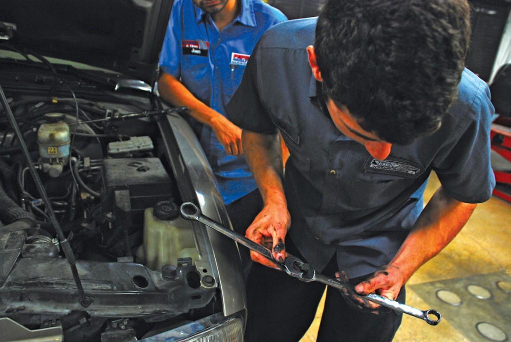 John Villeneuve decides which size wrench to use.