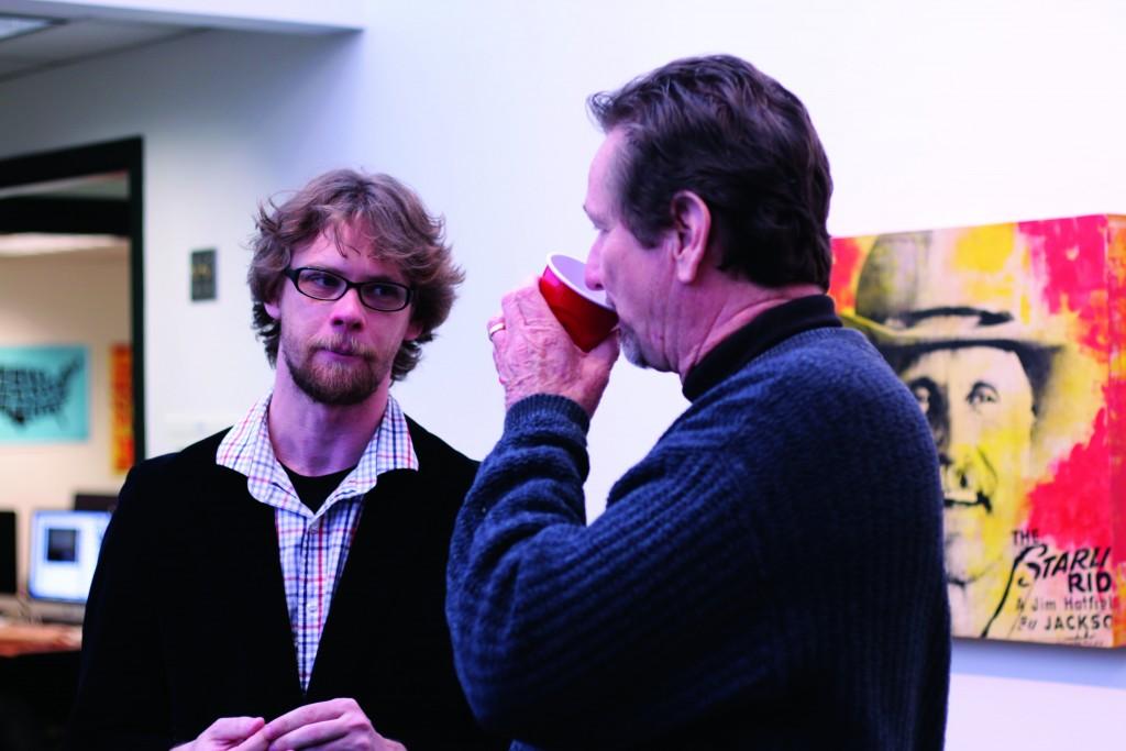 Director of the Atrium Gallery, Ray-Mel Cornelius (right), talks art with Jonathon Kimbrell (left).