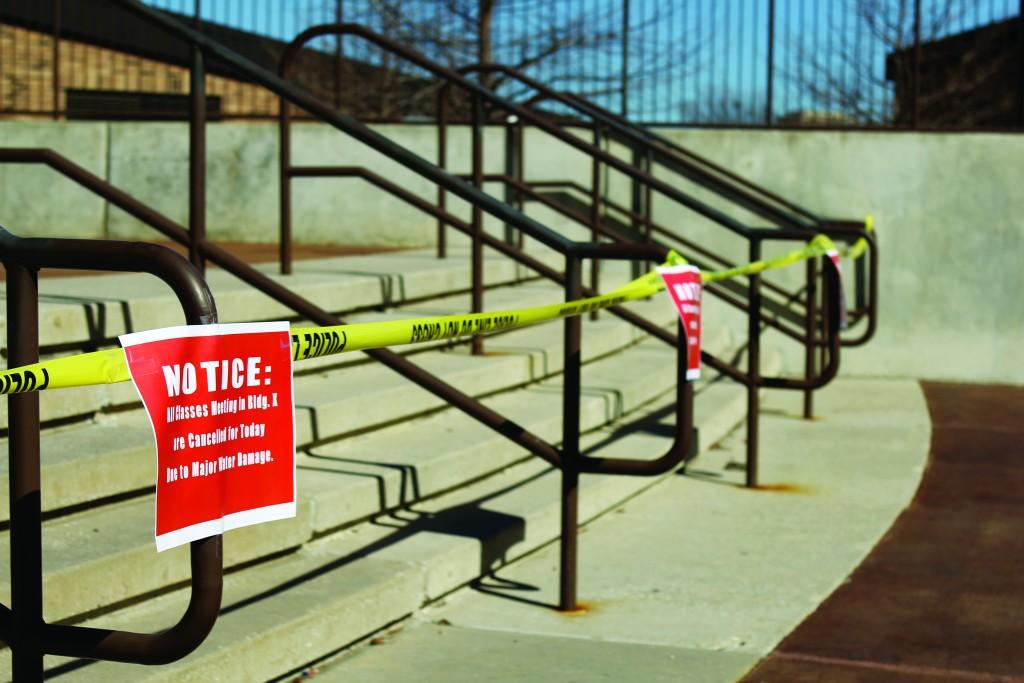 Photo by Willie R. Cole | Caution tape blocks the entrance to X Building Jan. 27 while signs alert students that classes are cancelled.