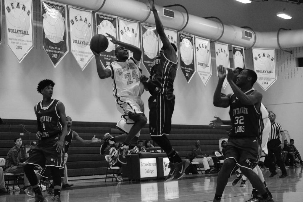 Brookhaven guard Kenny Slocum (#24) leaps for a shot at the net while surrounded by Mountain View College opposition.