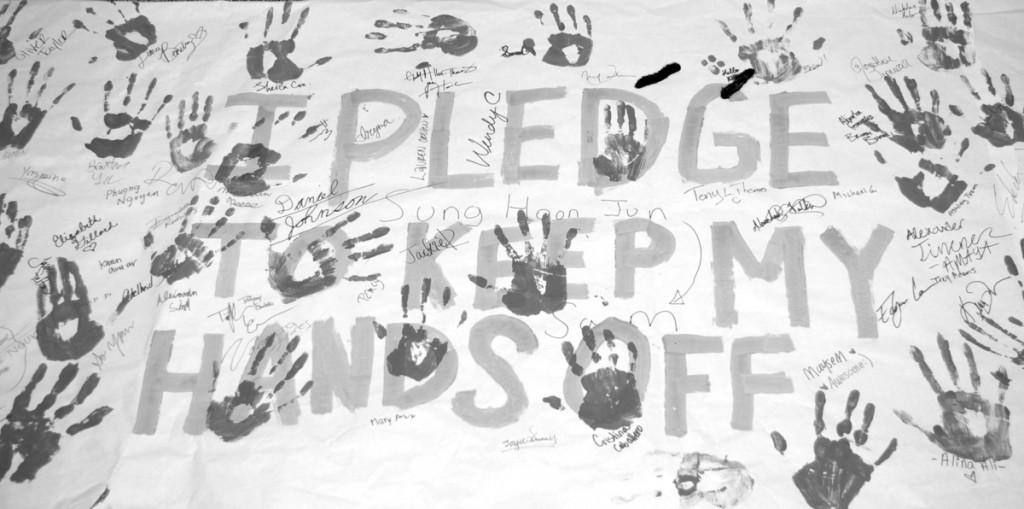 Photo by Jasmine Torres | A red, white and blue banner, laid out by the Rotaract Club, reads, "I pledge to keep my hands off,” prompting Brookhaven College students to commit to a drug-free lifestyle.