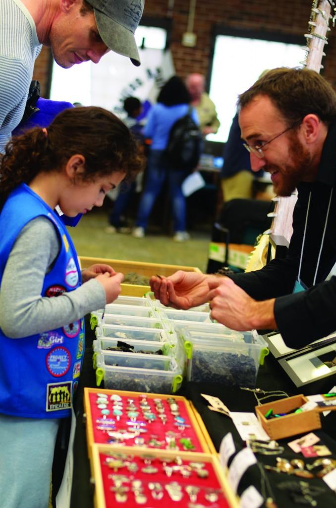 Wesley Kirpach shows a Daisy Scout his collection of fossils