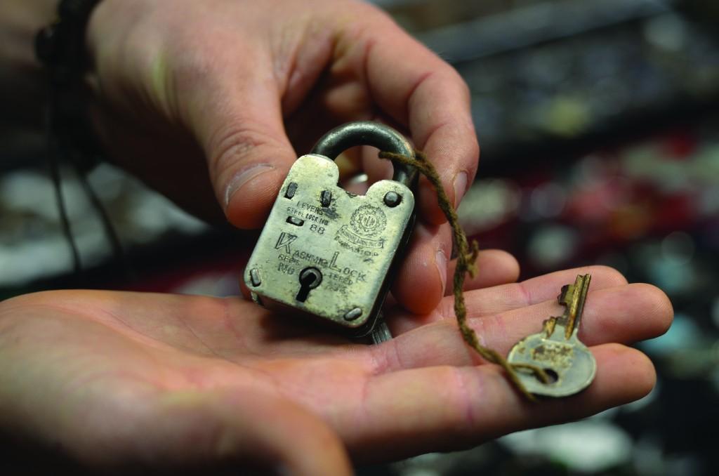 A vendor shows his 80-year-old padlock found in India