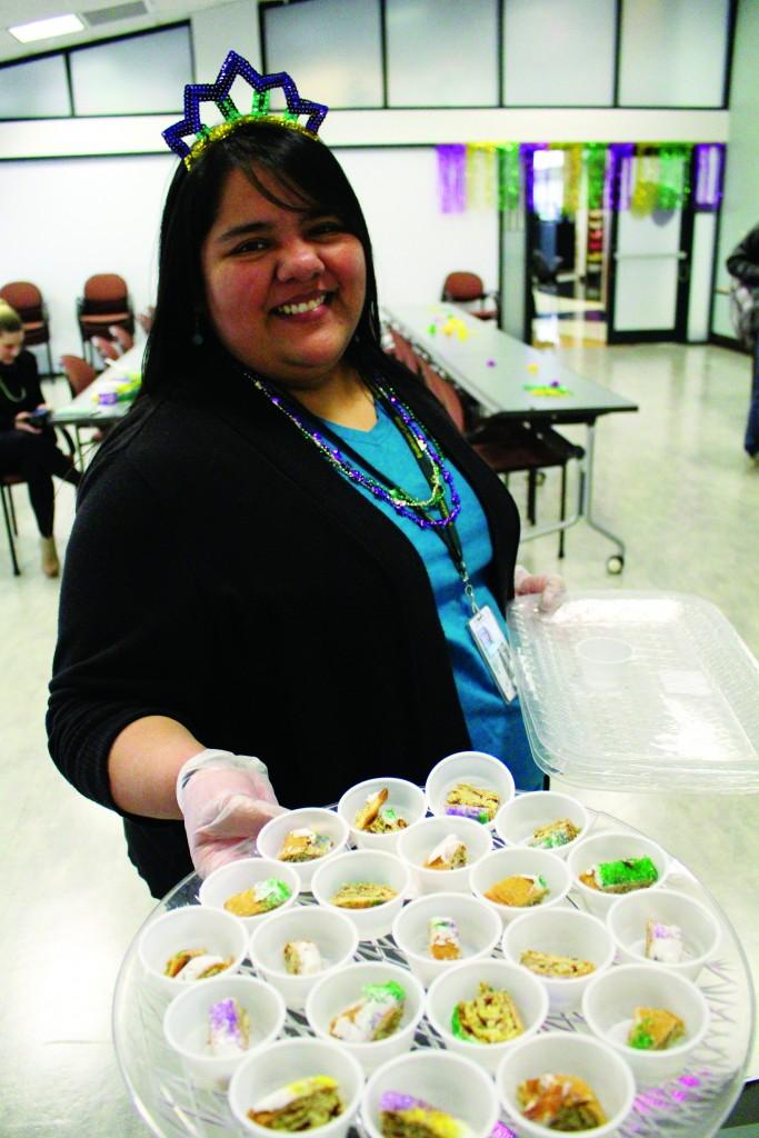 Rebekah Benavides, Office of Student Life program coordinator, holds a tray of king cake.