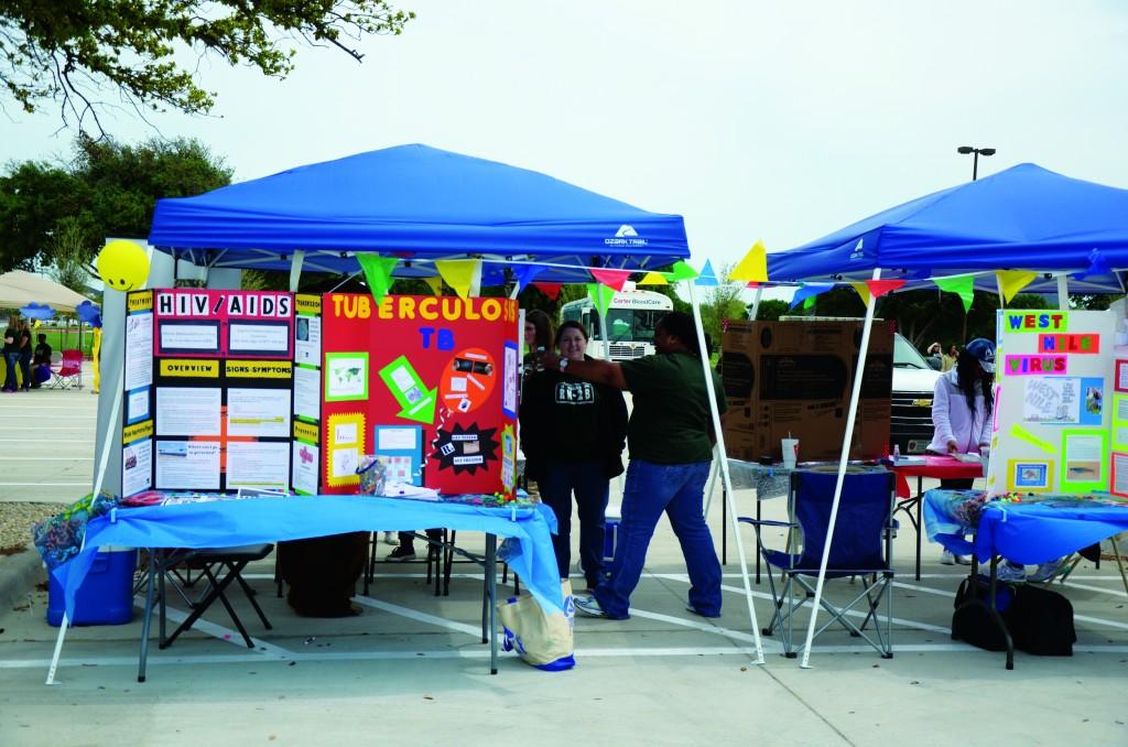 Several booths are set up to raise awareness of weather and health preparedness.