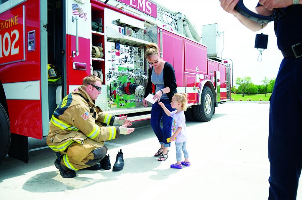 Photo by Travis Baugh | Courier Firefighter Cash Fortune interacts with event attendees.