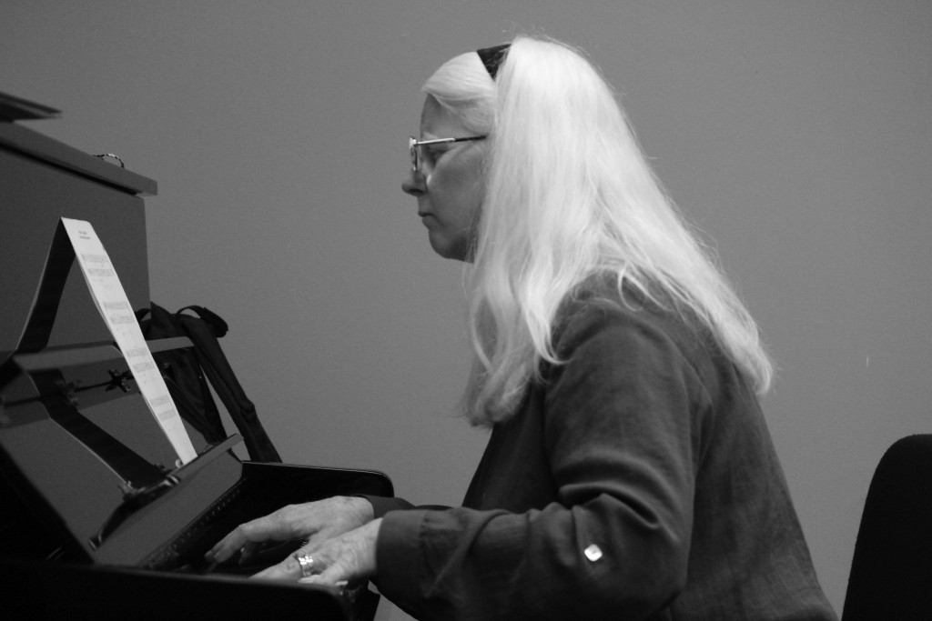 Baker plays the piano while teaching in her Music Theory IV class.
