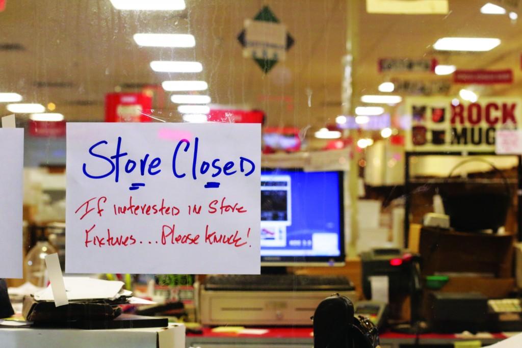 All Photos by Evan Henry | A sign hangs on the window of CD Source, alerting passersby of the store’s closing.