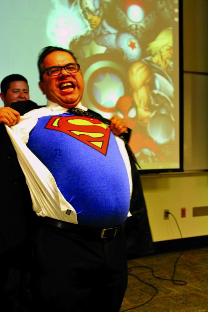 William De La Cruz | Courier       Brookhaven College librarian John Flores shows off his Superman shirt to kick off the event.