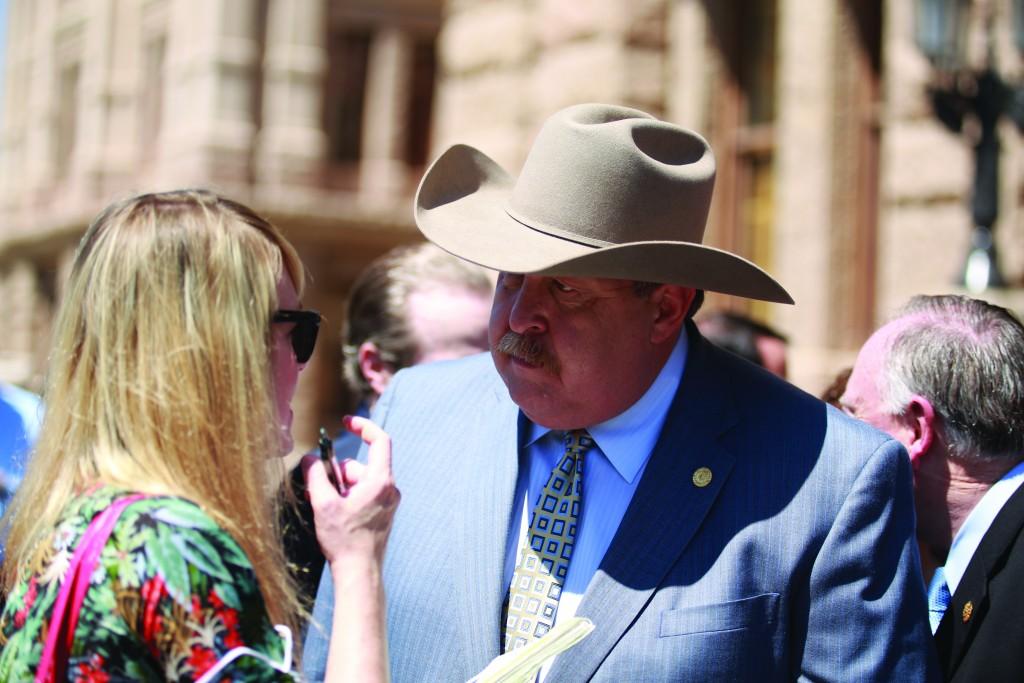 Texas State Rep. Cecil Bell speaks with a constituent at the Capitol Building.