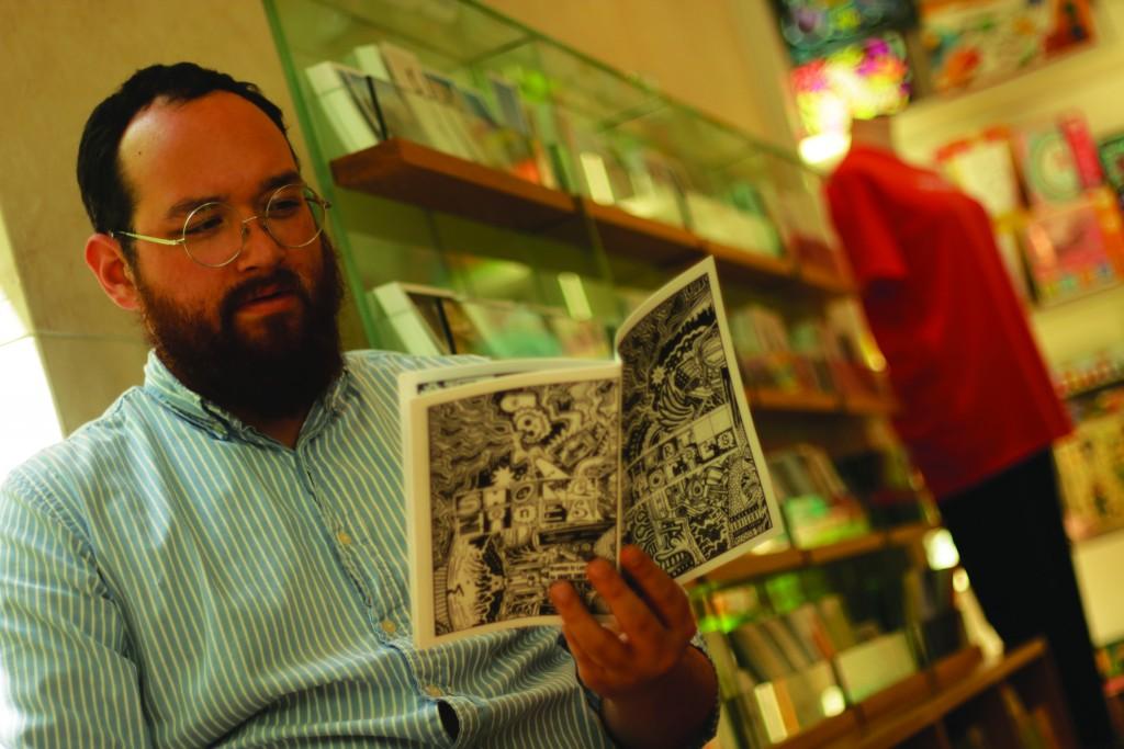 Photo by Evan Henry | Courier Randy Guthmiller reads his latest “SHAPES” -published zine, Larry Cary’s “Short Stories,” at the Nasher Gift Shop, where he works to fund his dreams. 