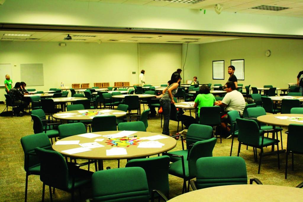 Students begin to show up for the event and take seats at tables splayed with art supplies.