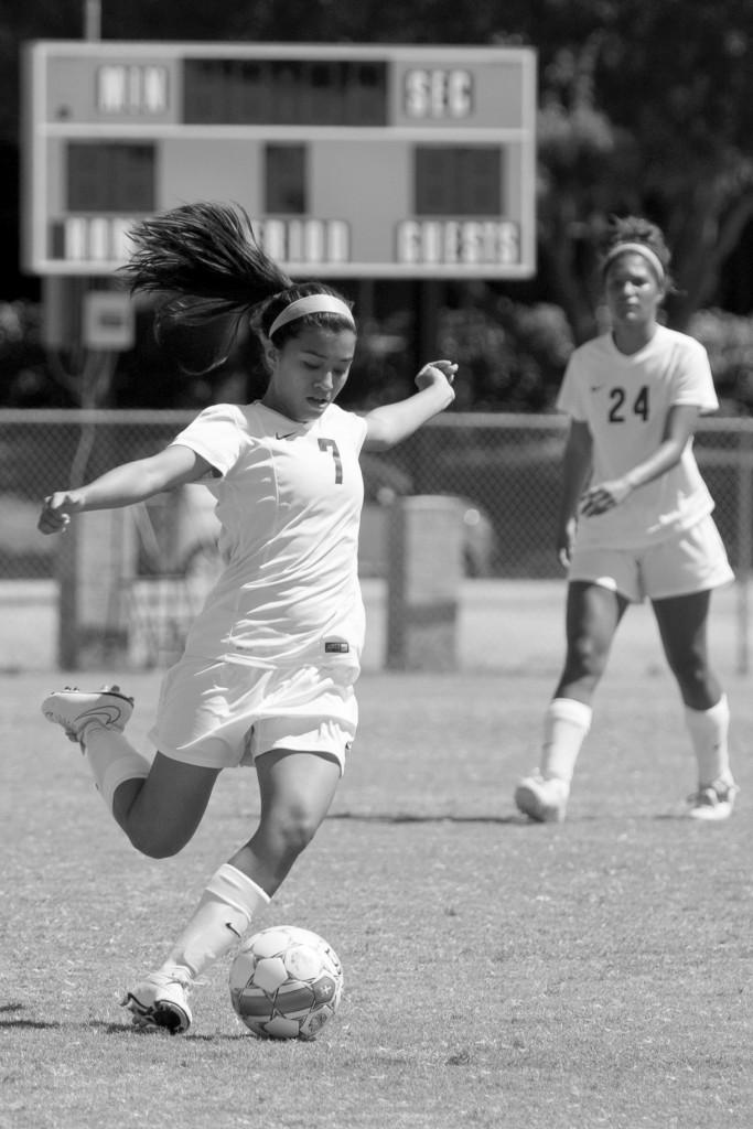 Midfielder Vanessa Gomez (#7) lines up to kick the ball downfield.