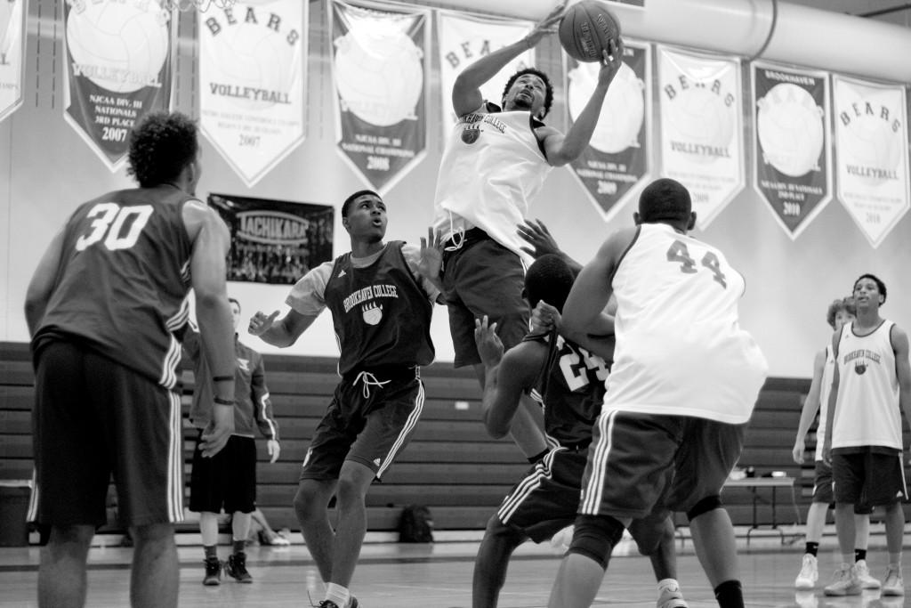 Jeremy Hicks (#24) attempts to block T.J. Hamrick (#33) from scoring a point