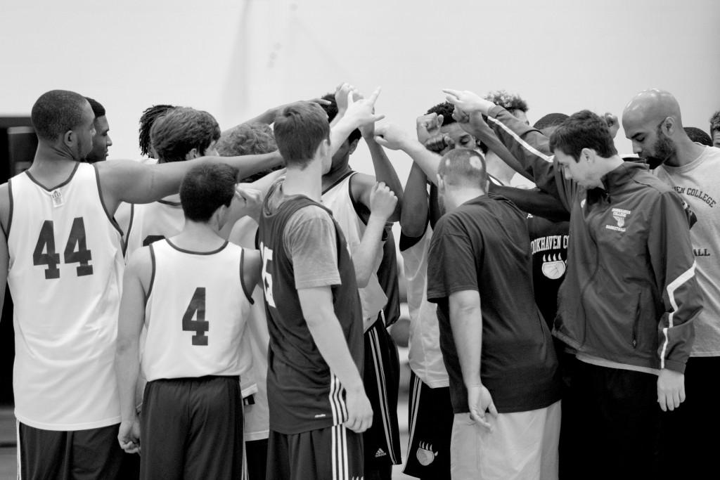 Photos by Ravin Lee | Coach Hurst rounds his team up in a huddle concluding practice