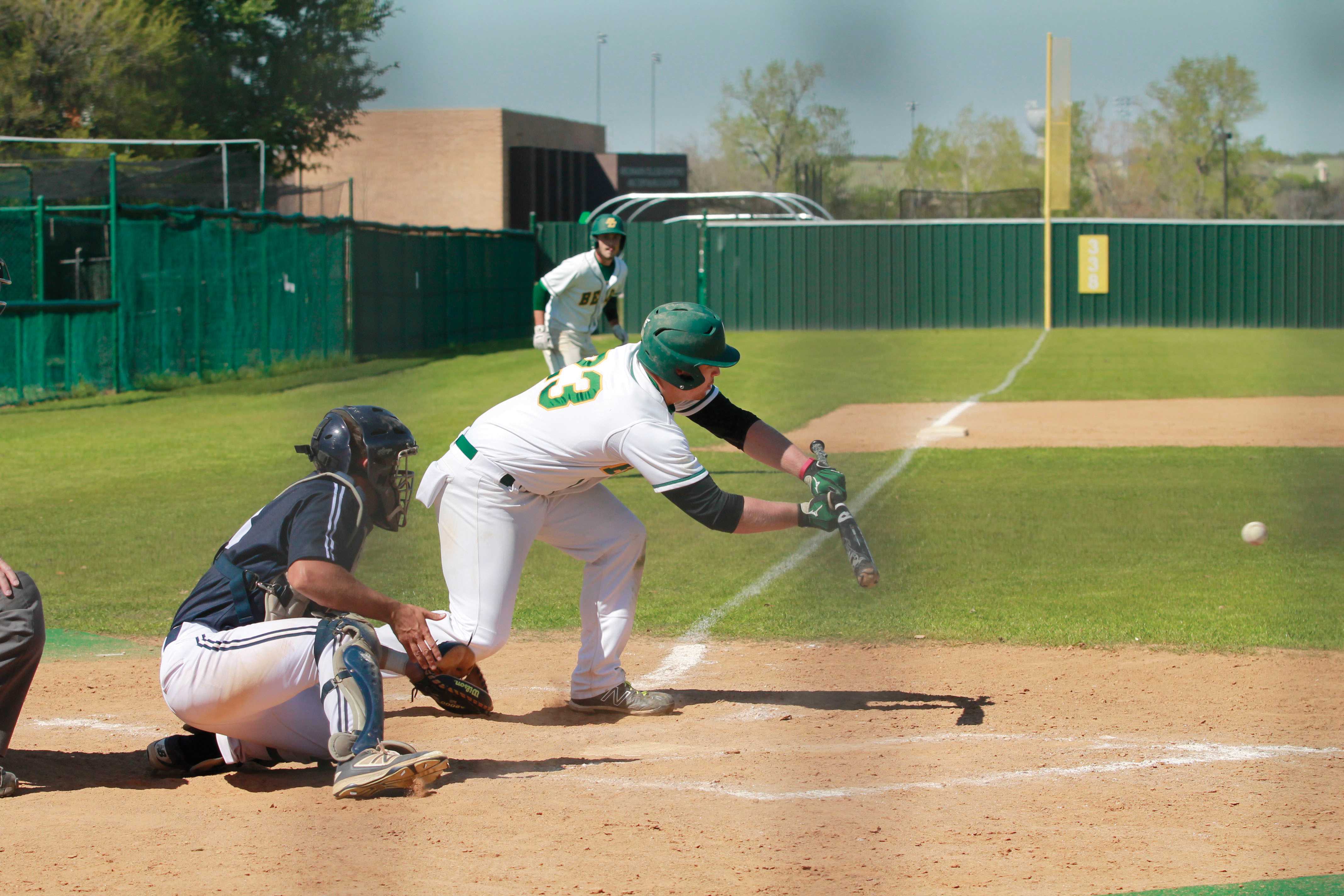Bear Brian Canida (#23) prepares to lay down the game-winning bunt on a suicide squeeze play in the bottom of the eighth inning to plate Adam Diehl (#14) from third base to win 6-5