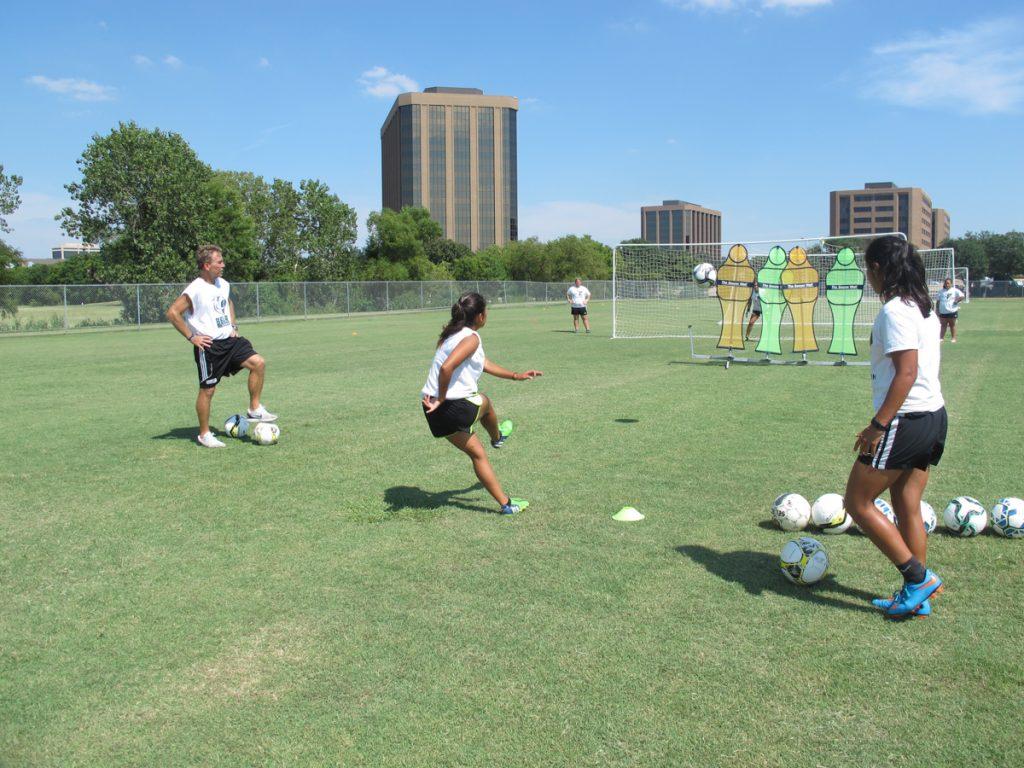 Photos by Juan Betancourt Jim Elder, Brookhaven College soccer coach, watches as one of his players kicks a ball toward a Soccer Wall.