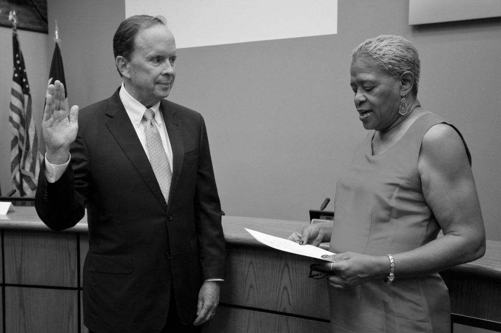 Photo courtesy of Ann Hatch Charletta Rogers Compton, board of trustees chair, swears in District 2 trustee-elect Philip Ritter on June 7.