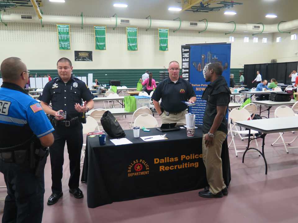 Photo by Stephon Smith Senior Cpl. Dan White (right) and Mike Friend (left) discuss the recruiting process for the Dallas Police Department for applicants during the Career Fair Oct. 13.