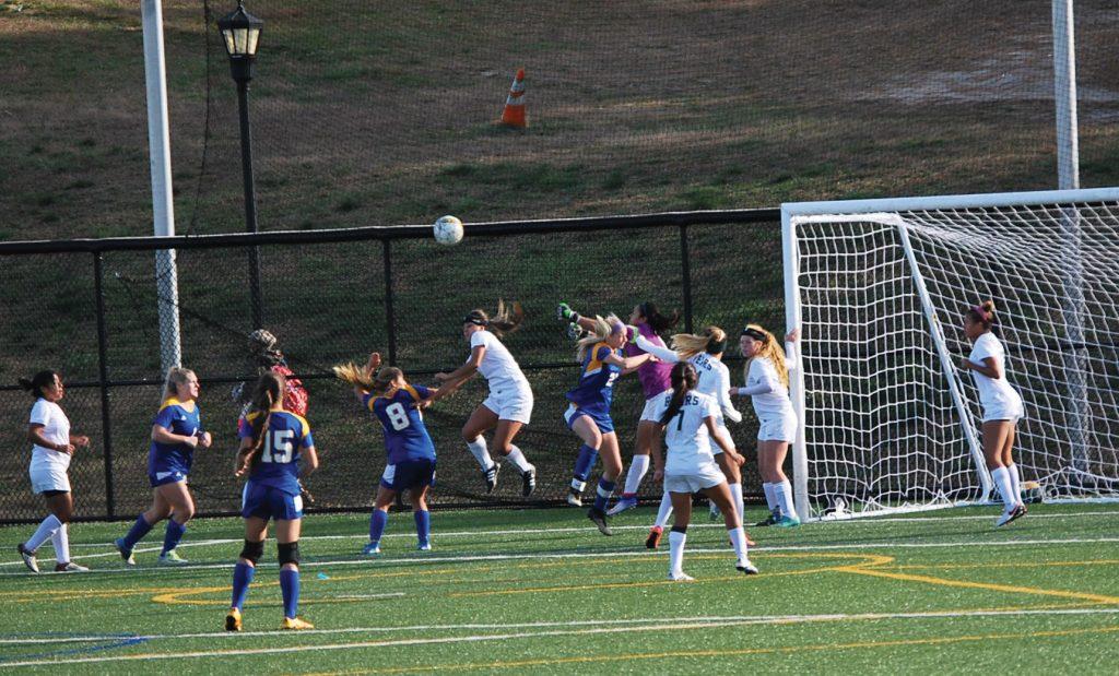 Photo courtesy of Nora Lopez Daniela Marin, Lady Bear goalkeeper, attempts to punch the ball away while teammate Brenda Hernandez (center) jumps to clear the ball from a Raptors corner kick attempt. 