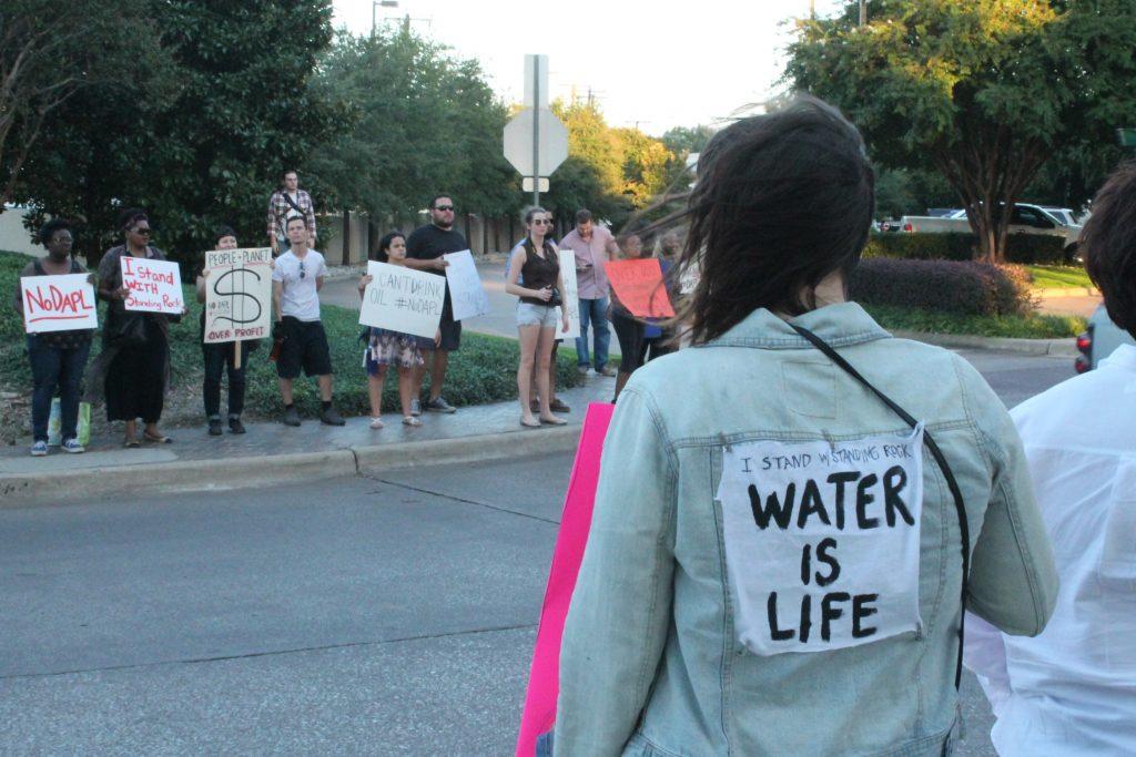 Photo by Stephanie Salas-Vega Protesters line up with signs outside the headquarters of Energy Transfer Partners, the company responsible for the Dakota Pipeline Project, in Dallas Nov.1. 