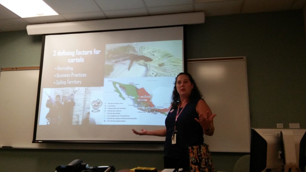 Photo by Juan Betancourt Jennifer Trujillo, an El Centro College English professor, explains motives behind some Mexican cartels. 