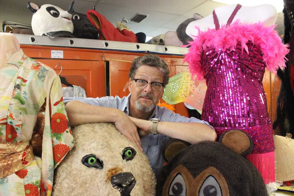 Photos by Ellen Case Michael Robinson, owner of Dallas Costume Shoppe, poses with several costume pieces in the shop, located outside Deep Ellum.