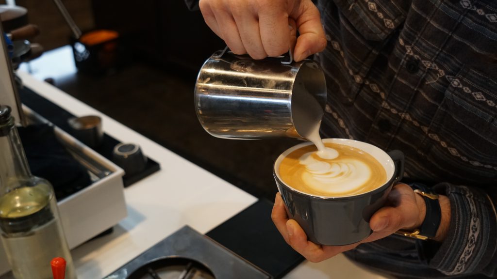  Photo by Beth Delagi | Menchaca pours steamed milk into a hot latte