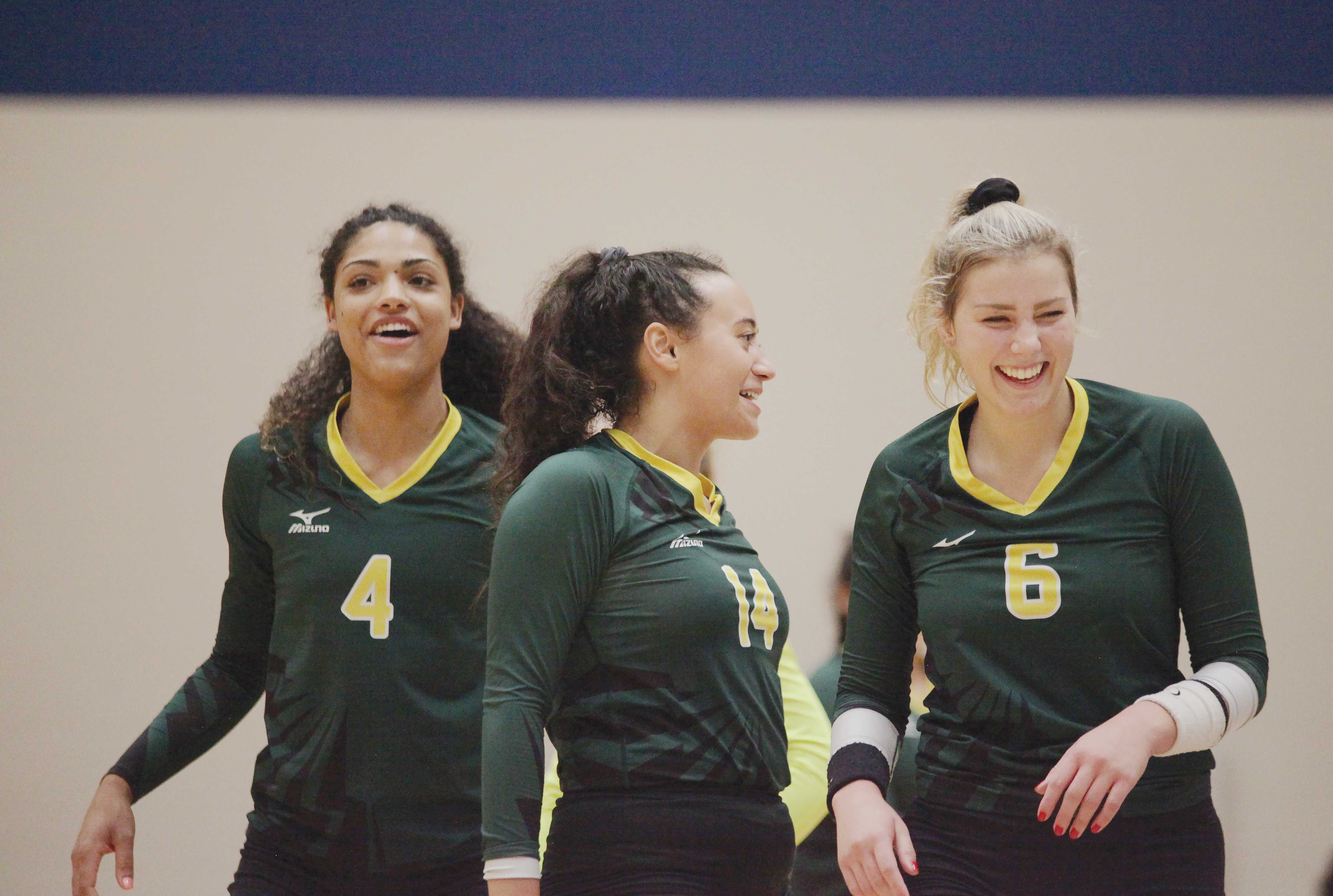 Photo by Malen Blackmon | From left: Lady Bears outside hitter Yasmin Miller (#4), setter Morgan Frisby (#14) and outside hitter Faith Fetzer (#6) celebrate after a point earlier this season against North Lake College.