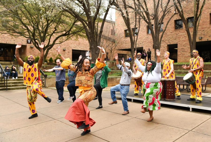 <strong>Photo by Rosa Poetschke |</strong> Carmen McIver, student programs development coordinator, and spectators join the Bandan Koro African Drum & Dance Ensemble in the International Courtyard for a celebratory dance during Brookhaven College's 2019 Taste of Soul event held Feb. 27, 2019. The ensemble will return to this year's taste of soul Feb. 26.