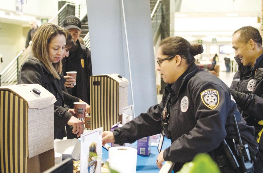 <strong>Photo by Brandon Donner</strong> Irma Martinez, (left) administrative assistant, socializes with officers while getting a cup of coffee in the S Building lobby during Coffee with a Cop Jan. 22.