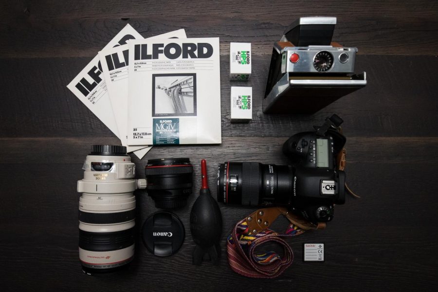 photo of camera products - lens, camera, photo paper and film