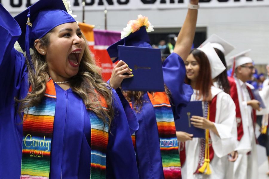 Cindy Ortiz Jaimes, a Dallas College School of Health Sciences graduate, rallies the crowd at the 2 p.m. June 26 graduation ceremony as she makes her way back to her seat after receiving her associate degree.