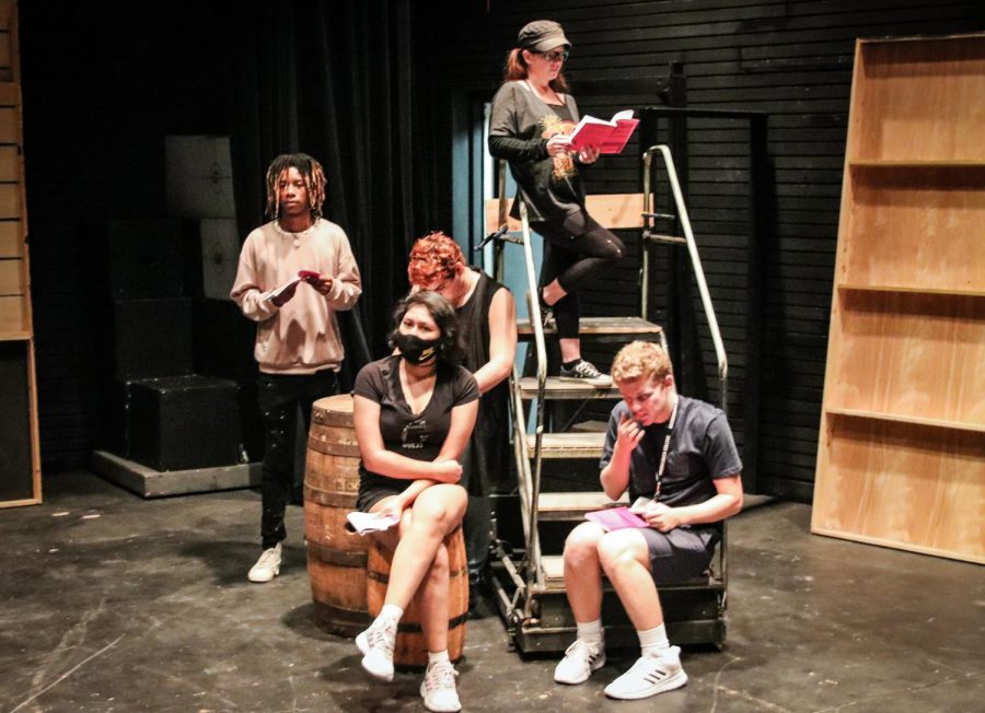 Cast members in various sitting positions at Black Box Theater