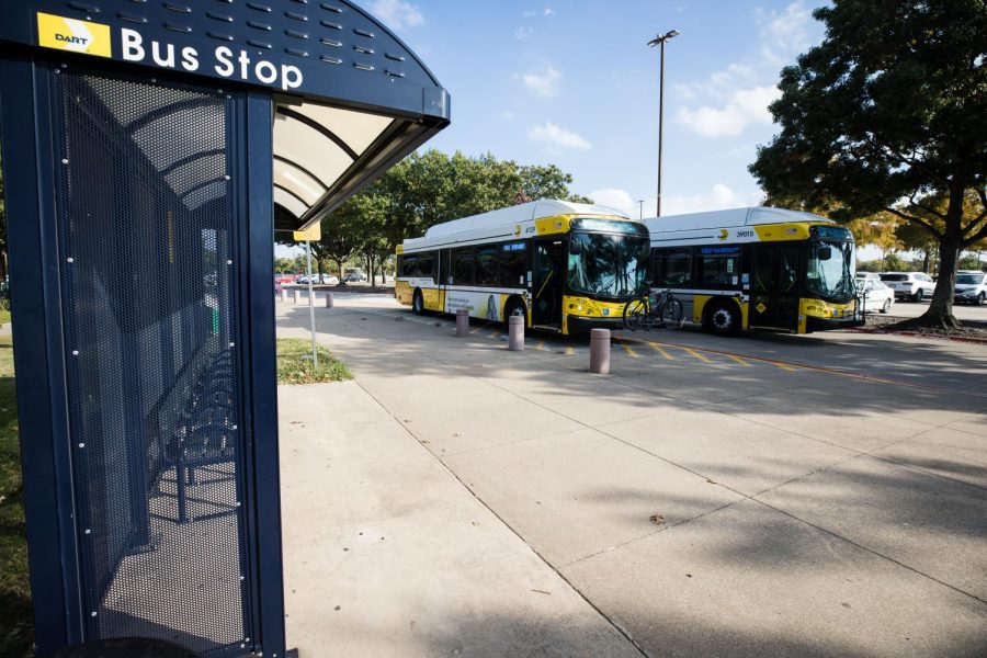 Photo of bus stop with two approaching buses